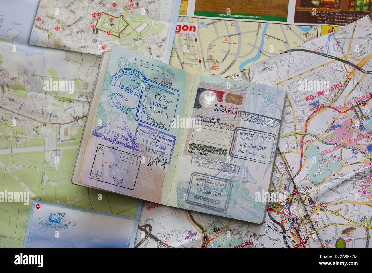 Open pages of Australian passport with visa stamps on travel maps. Stock Photo