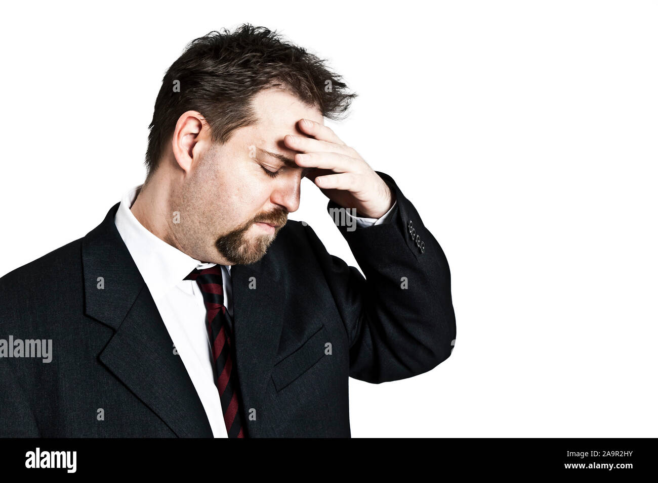 A handsome young man in business suit holding forehead, Modelrelease, Stock Photo
