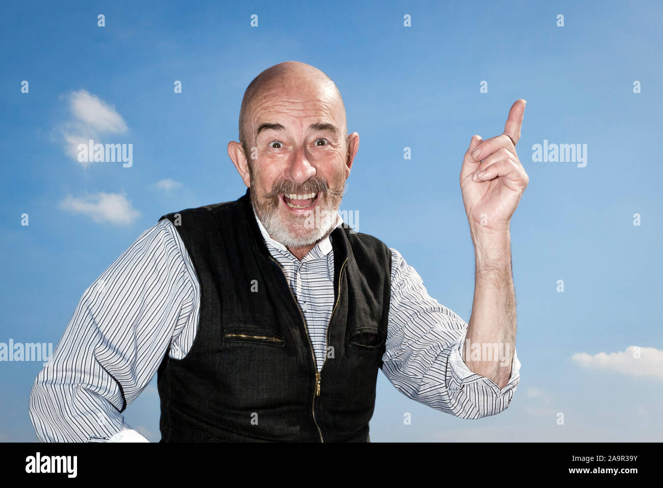 An old man with a grey beard is having an idea Stock Photo