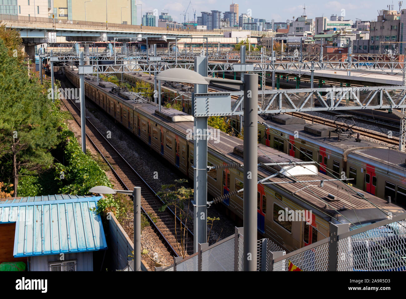 Railroad infrastructure and train passing by. Railway power supply ...