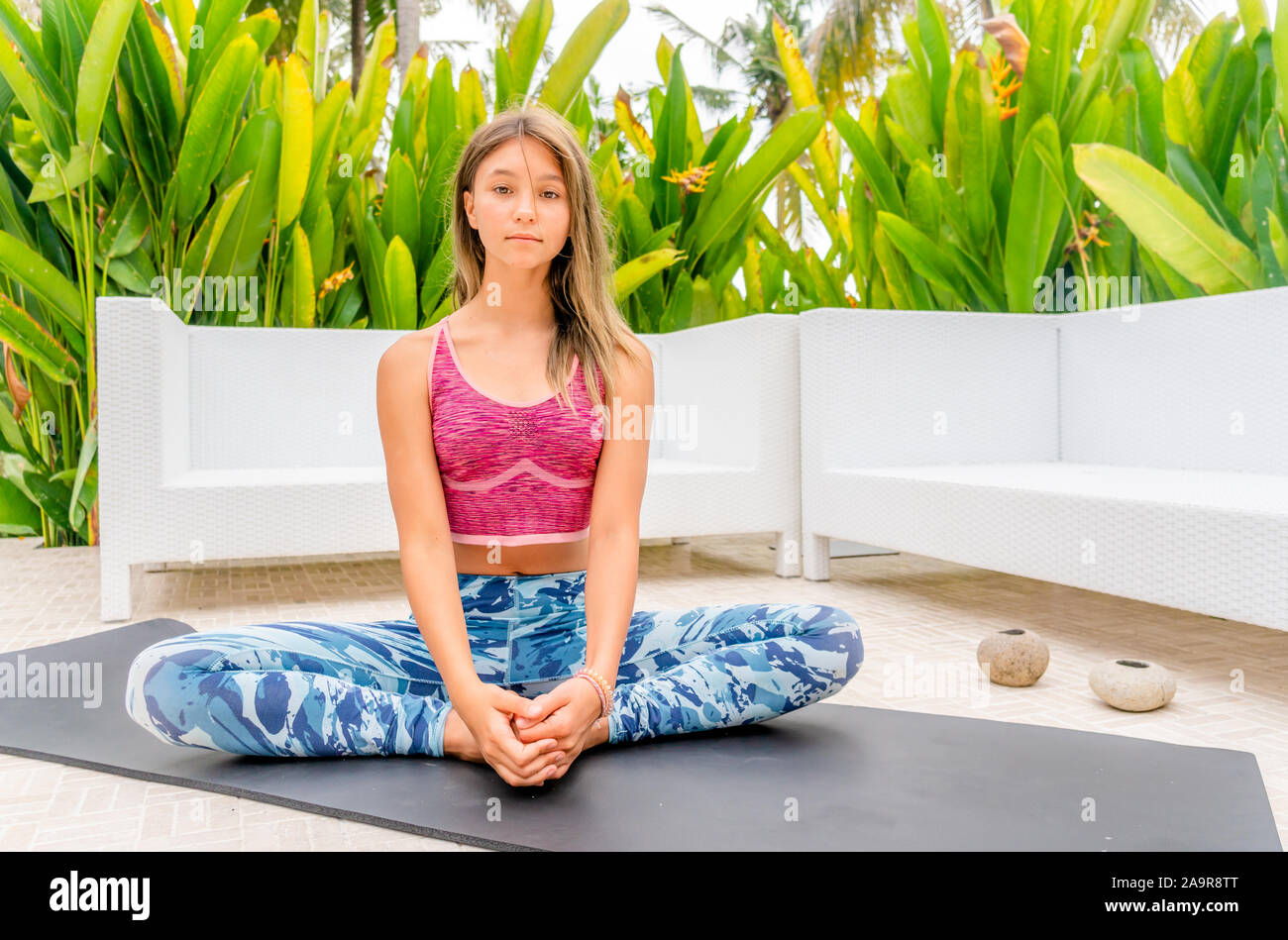 Young girl doing yoga in the garden Stock Photo - Alamy
