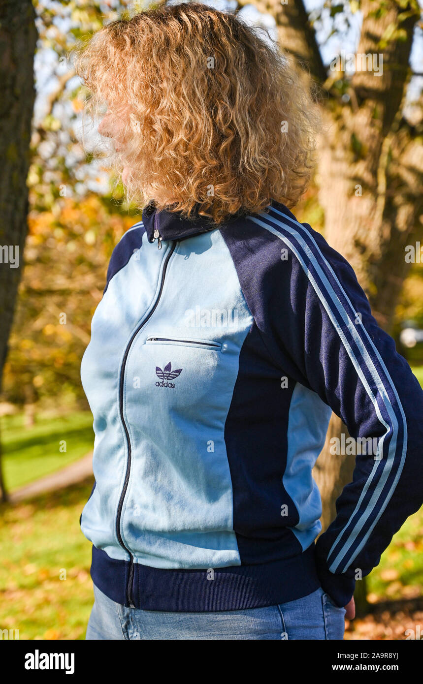Mature middle aged woman wearing a retro Adidas tracksuit top made in the  1970s Photograph taken by Simon Dack Stock Photo - Alamy