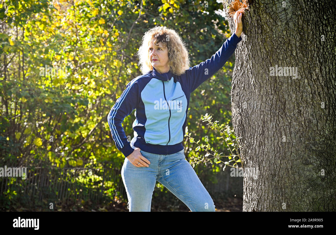Mature middle aged woman wearing a retro Adidas tracksuit top made in the 1970s - Editorial Use Only Stock Photo