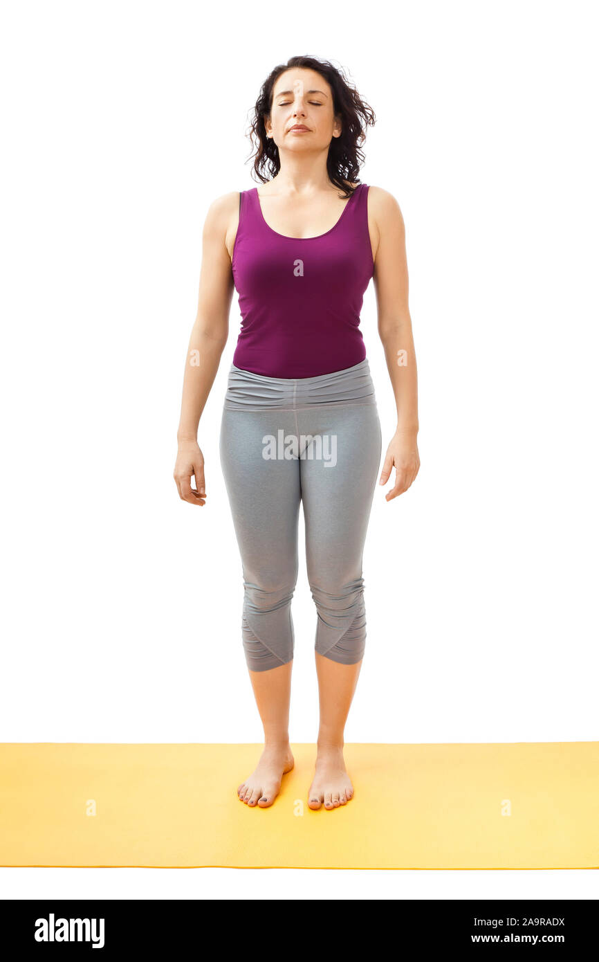Eine huebsche Frau, die auf einer Isomatte Yoga-Uebungen durchfuehrt Stock Photo