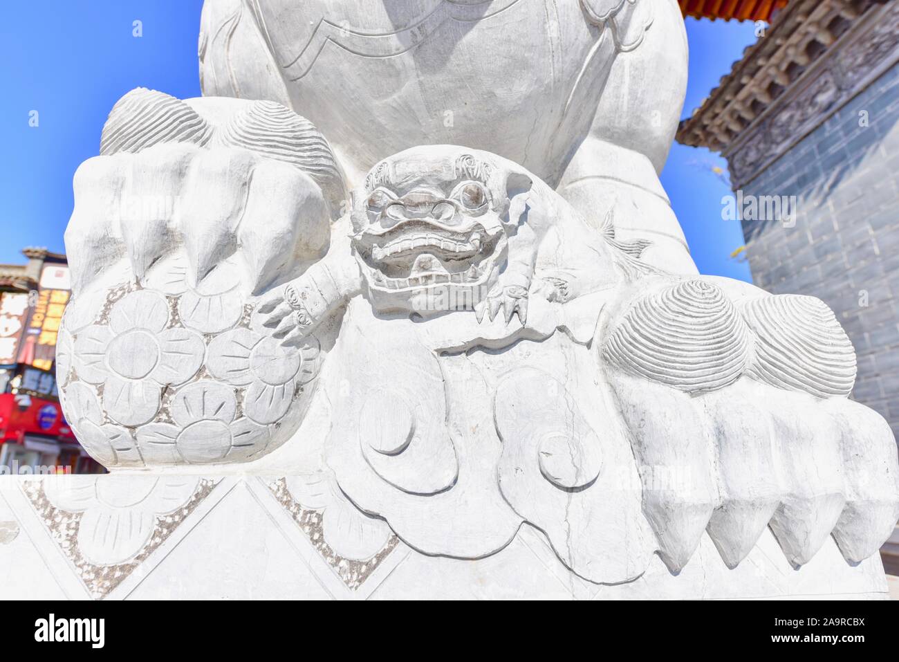 Stone-Carved Lion Guardian Sculpture at Guandu Ancient Town Stock Photo