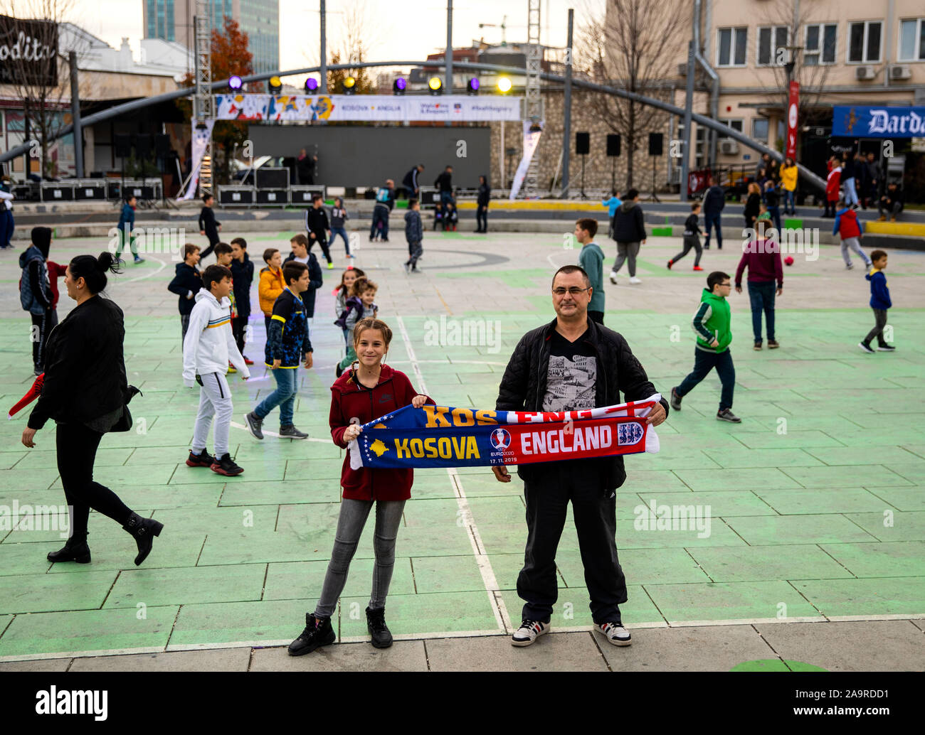 Fans hold up a half and half scarf ahead of the UEFA Euro 2020 Qualifying match at the Fadil Vokrri Stadium, Pristina. Stock Photo