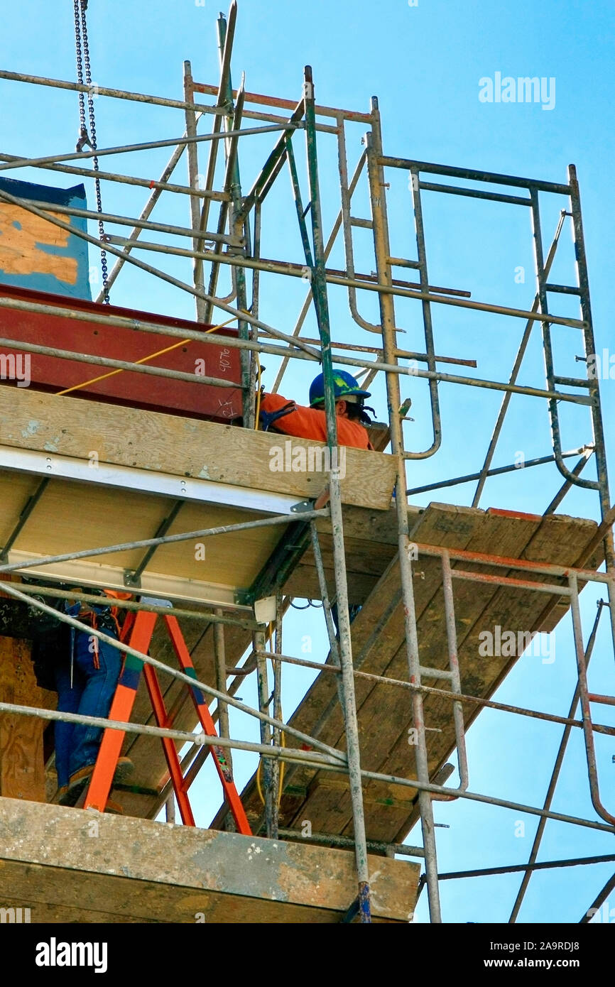 Construction workers wearing safety equipment hires stock photography