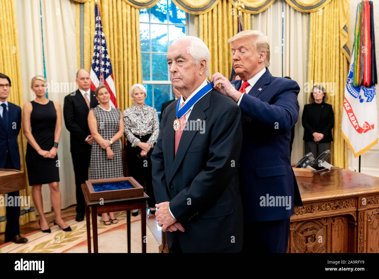 President Donald J. Trump presents the Presidential Medal of Freedom, the nation’s highest civilian honor, to legendary race car driver and race team owner Roger Penske, Thursday, Oct. 24, 2019, in the Oval Office of the White House. Stock Photo