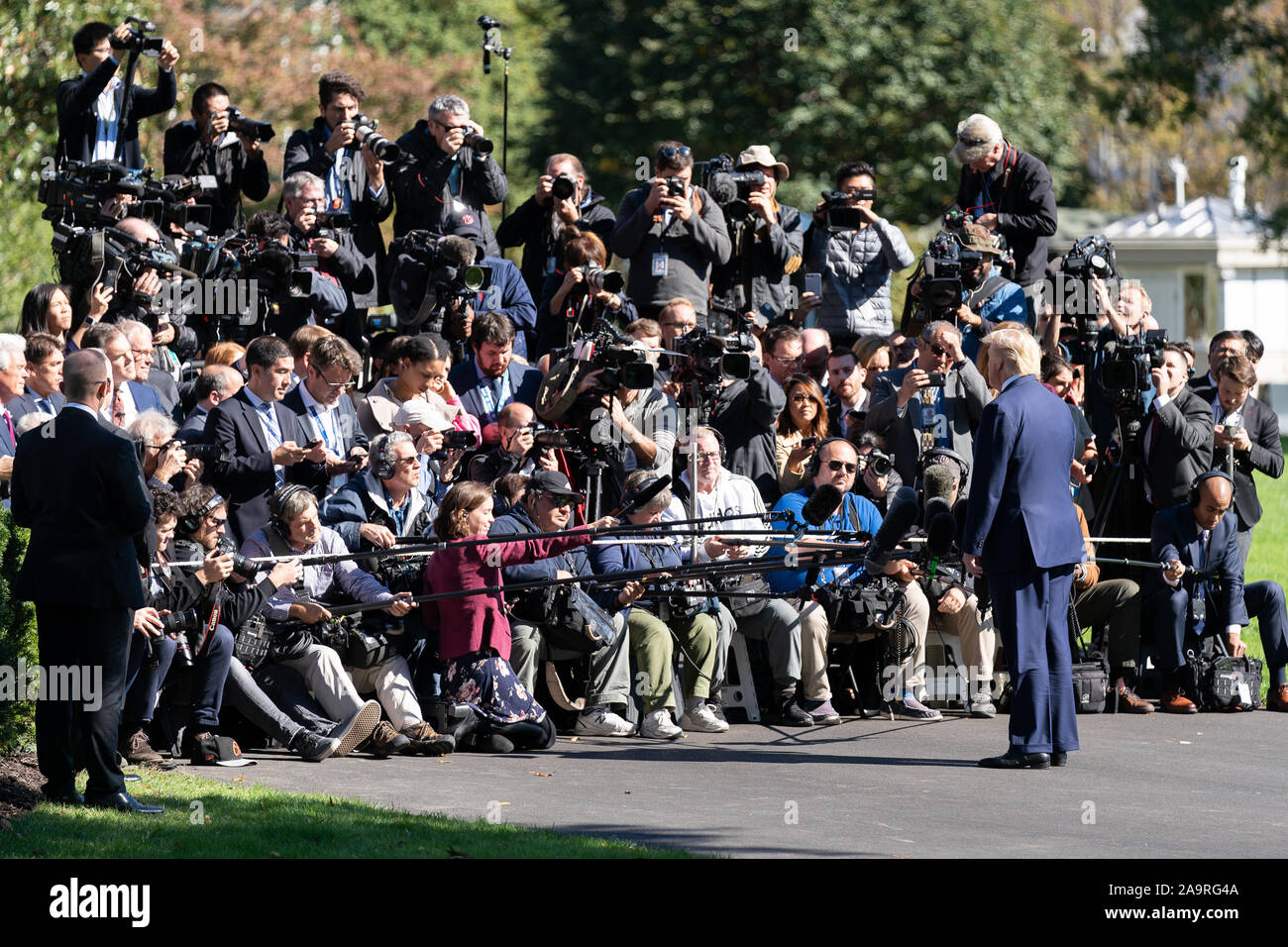 President Donald J. Trump talks to members of the press on the South Lawn driveway of the White House Wednesday, Oct. 23, 2019, prior to boarding Marine One to begin his trip to attend an energy conference in Pittsburgh. Stock Photo