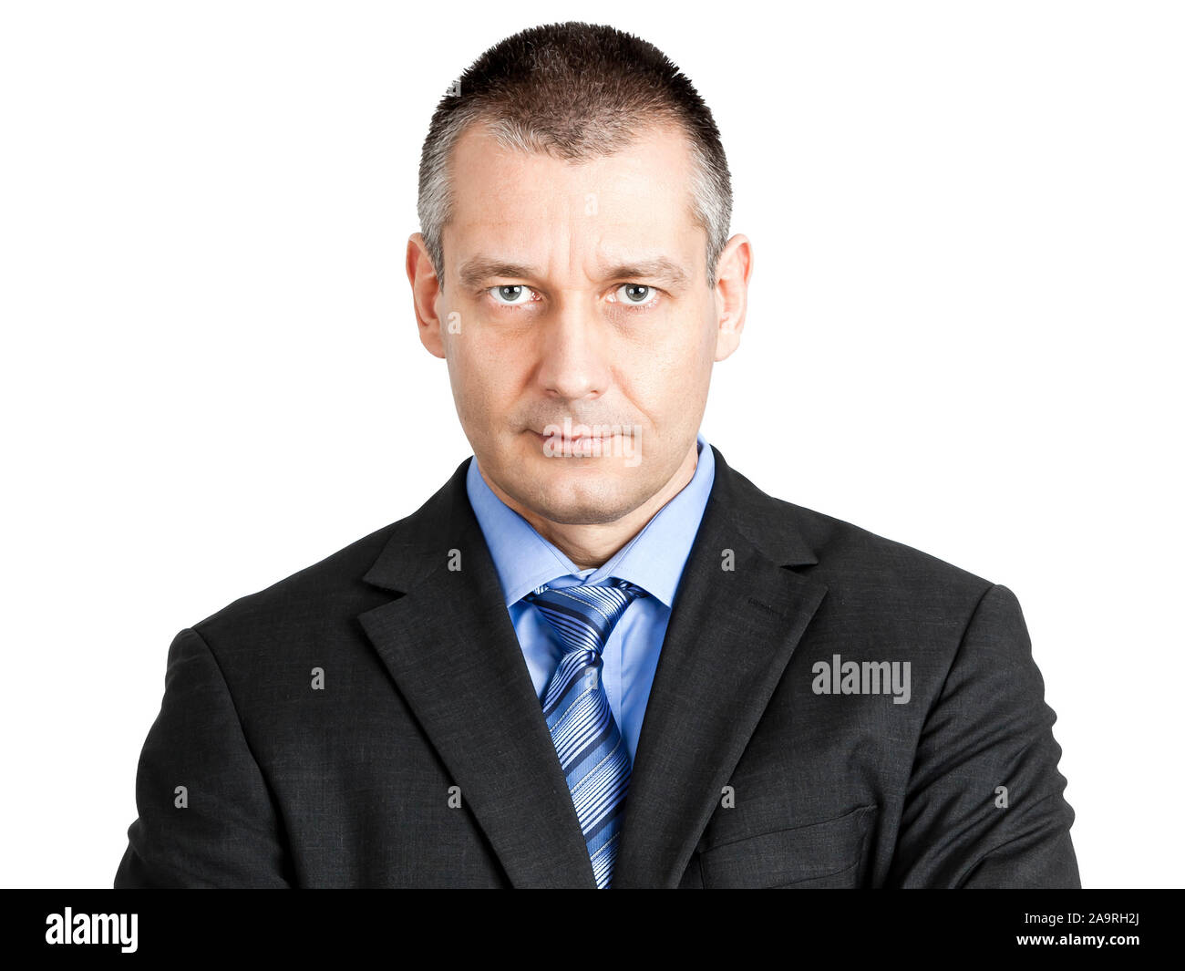 Ein Geschaeftsmann vor weissem Hintergrund, der sehr ernst aussieht Stock Photo