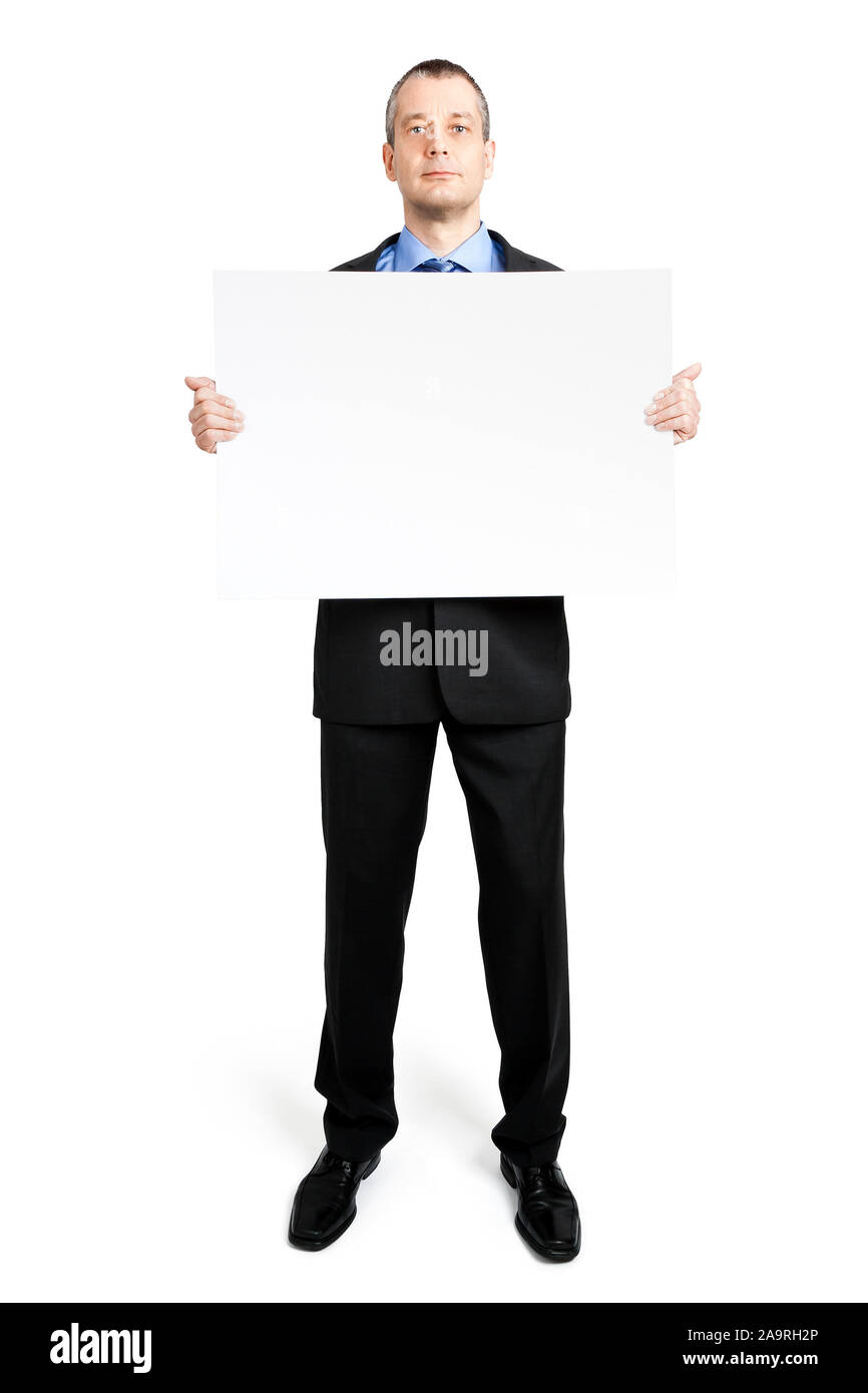 Ein Geschaeftsmann mit einem Schild in der Hand, vor weissem Hintergrund Stock Photo