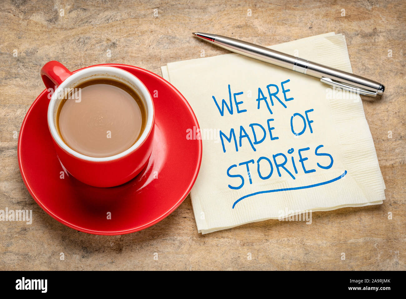 We are made of stories handwriting on a napkin with a cup of coffee