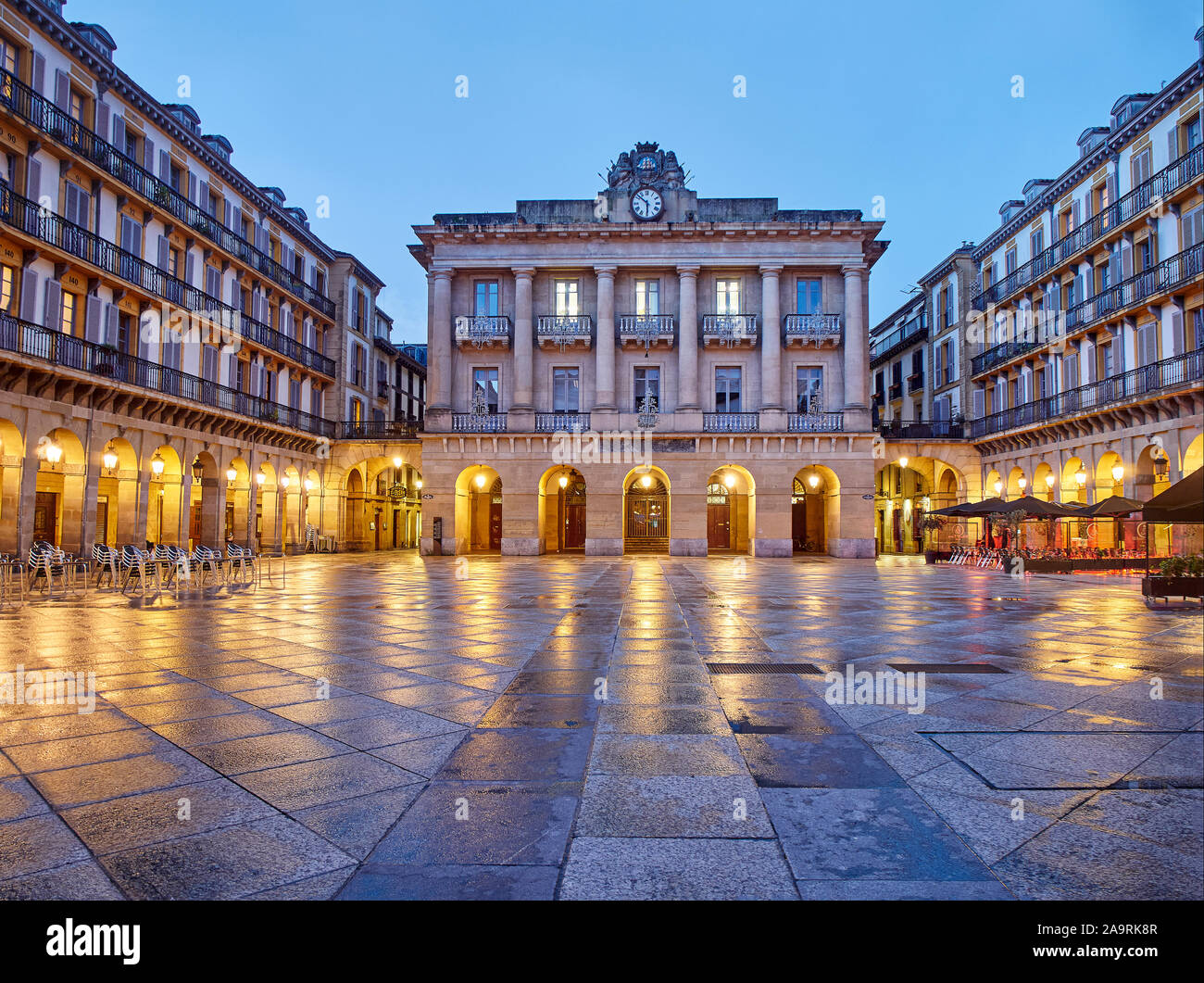 The Constitution square at nightfall (Plaza de la Constitucion). The central building in the background was, until 1947, the Town Hall of Donostia. Stock Photo