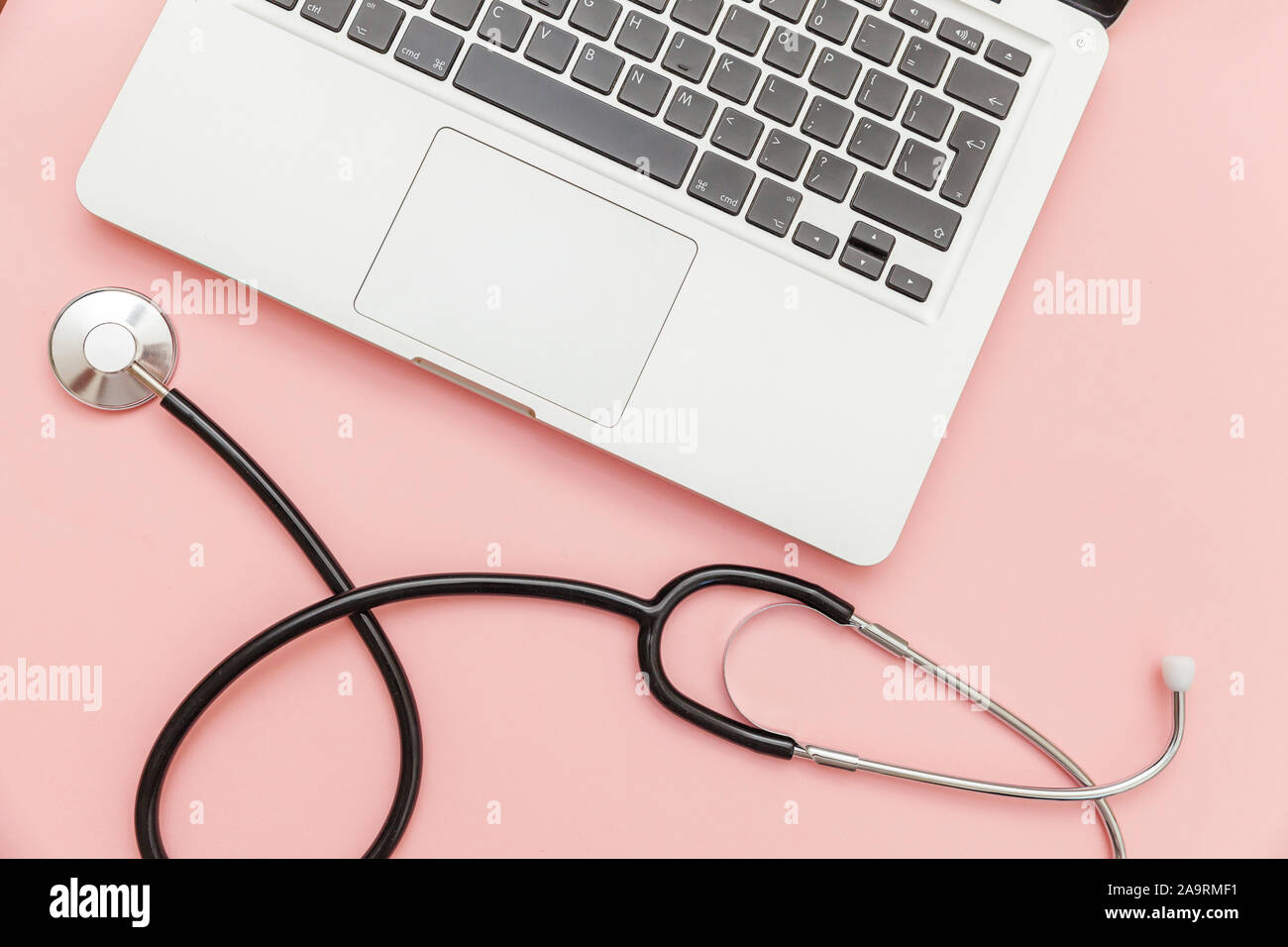 Stethoscope keyboard laptop computer isolated on pink background ...