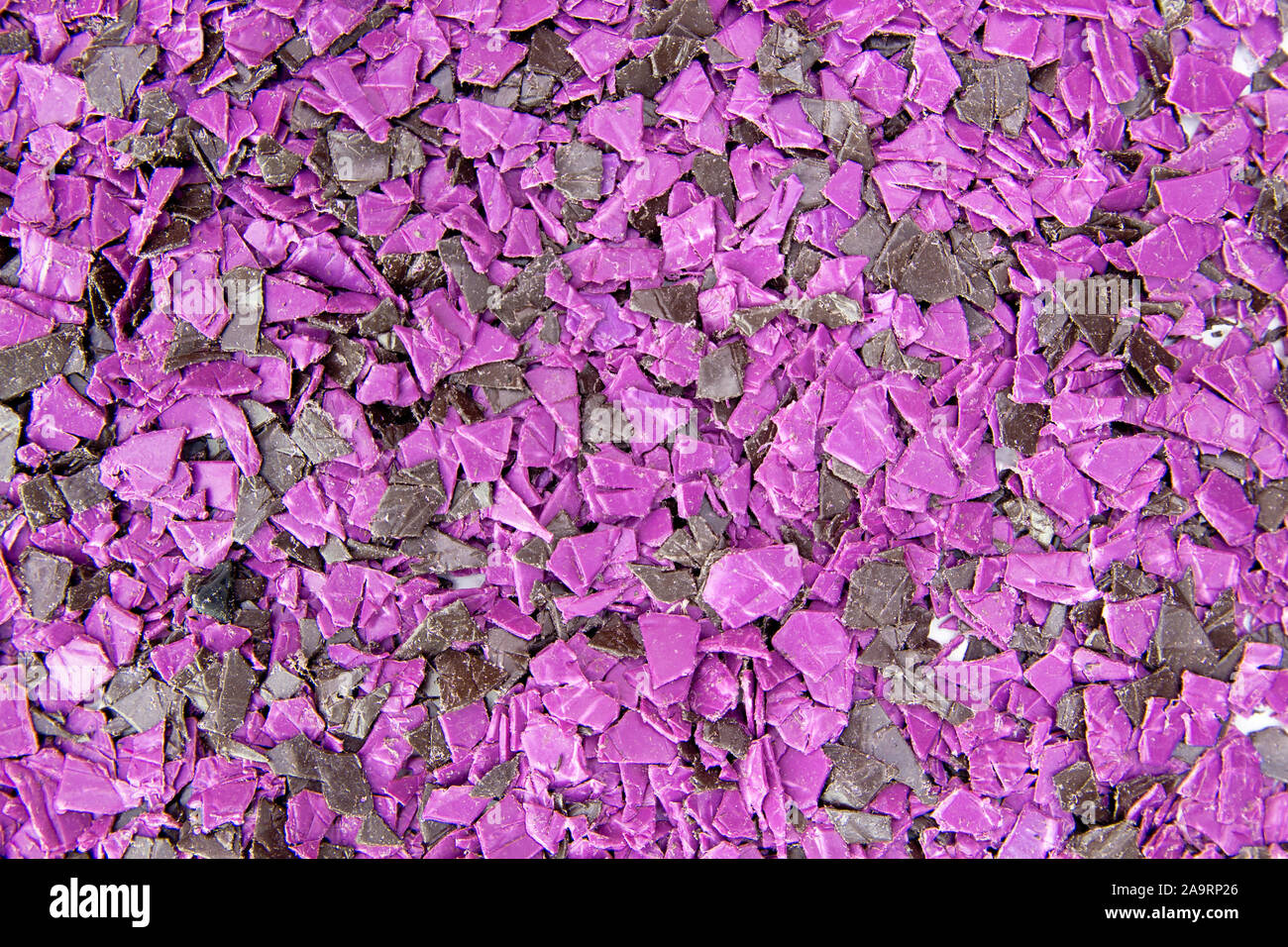 pieces of plastic for recycling. Crushed polyethylene, polypropylene close-up. The view from the top Stock Photo