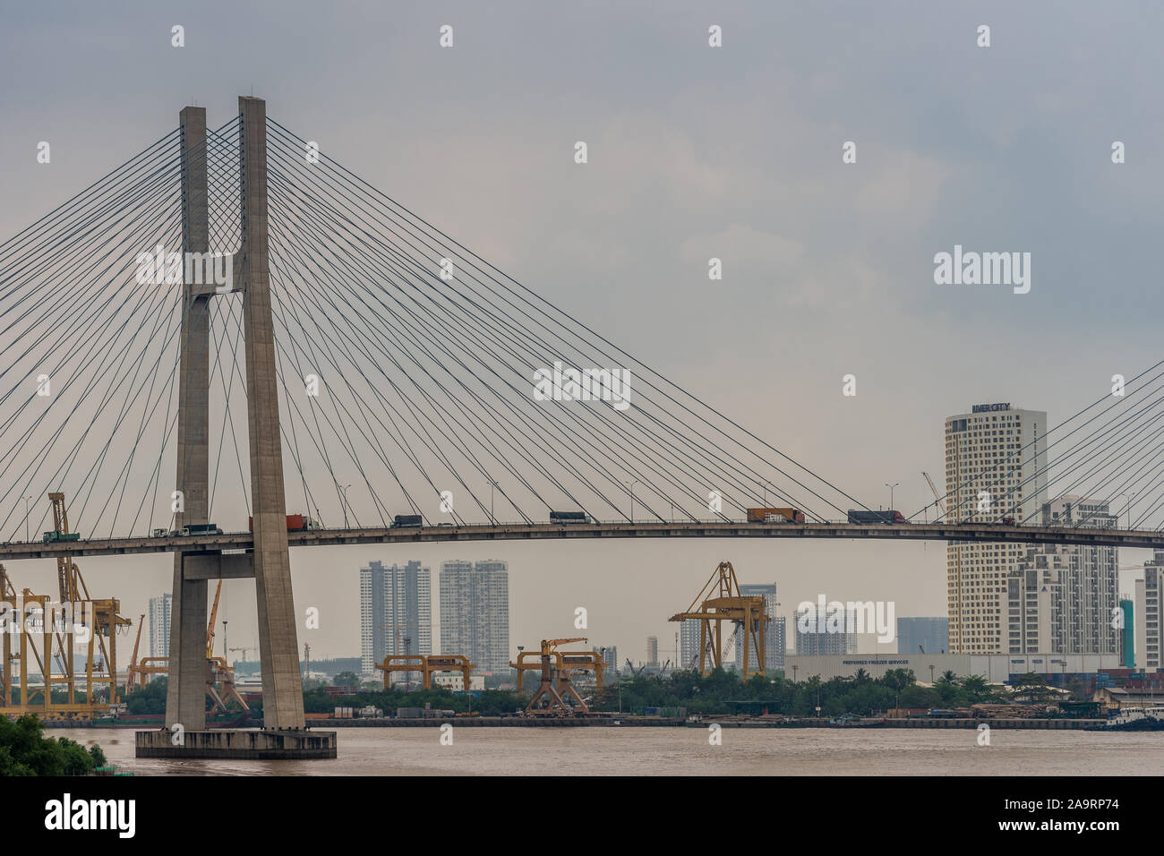Ho Chi Minh City Vietnam - March 12, 2019: Looking soutj: Eastern pylon and span of Cau Phu My suspension bridge over Song Sai Gon river under light b Stock Photo