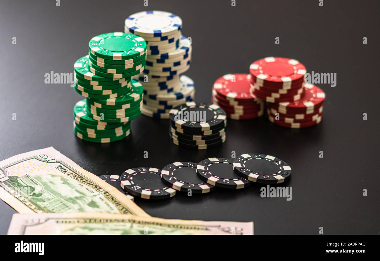 Stacks of poker chips and dollar bills on black background. Poker concept,  chips and money Stock Photo - Alamy