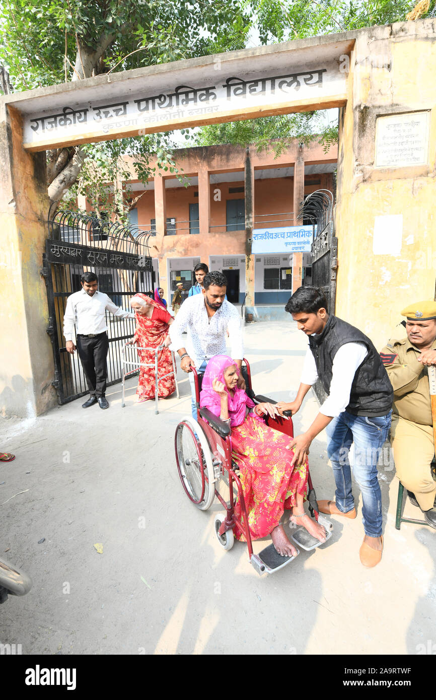 Elderly voters being carried out of the polling booth after their voted in Civic Body Polls at Beawar, Rajasthan, India. Photo/Sumit Saraswat Stock Photo
