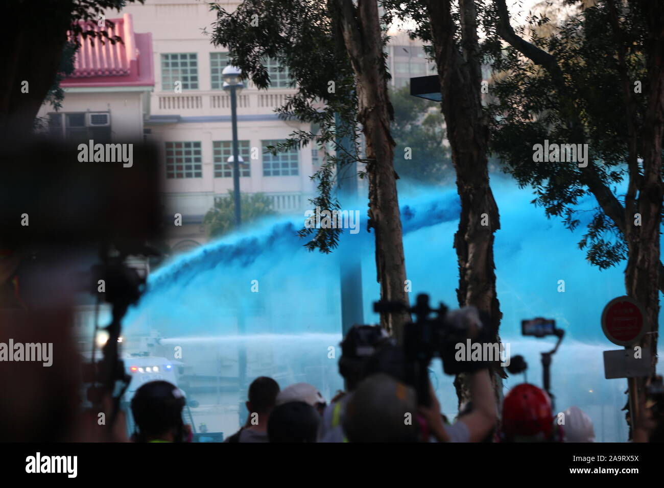Hong Kong, China. 17th Nov 2019.  A water cannon can be seen spraying water mixed with blue dye and pepper spray on Polytechnic University, the first time that a water cannon has been used at a university since the protests in Hong Kong first began in June. Used by police as a crowd control management method, the blue dye is used to mark protestors for identification later on and the pepper spray is used to increase its effectiveness. Credit: Katherine Cheng/Alamy Images. Stock Photo