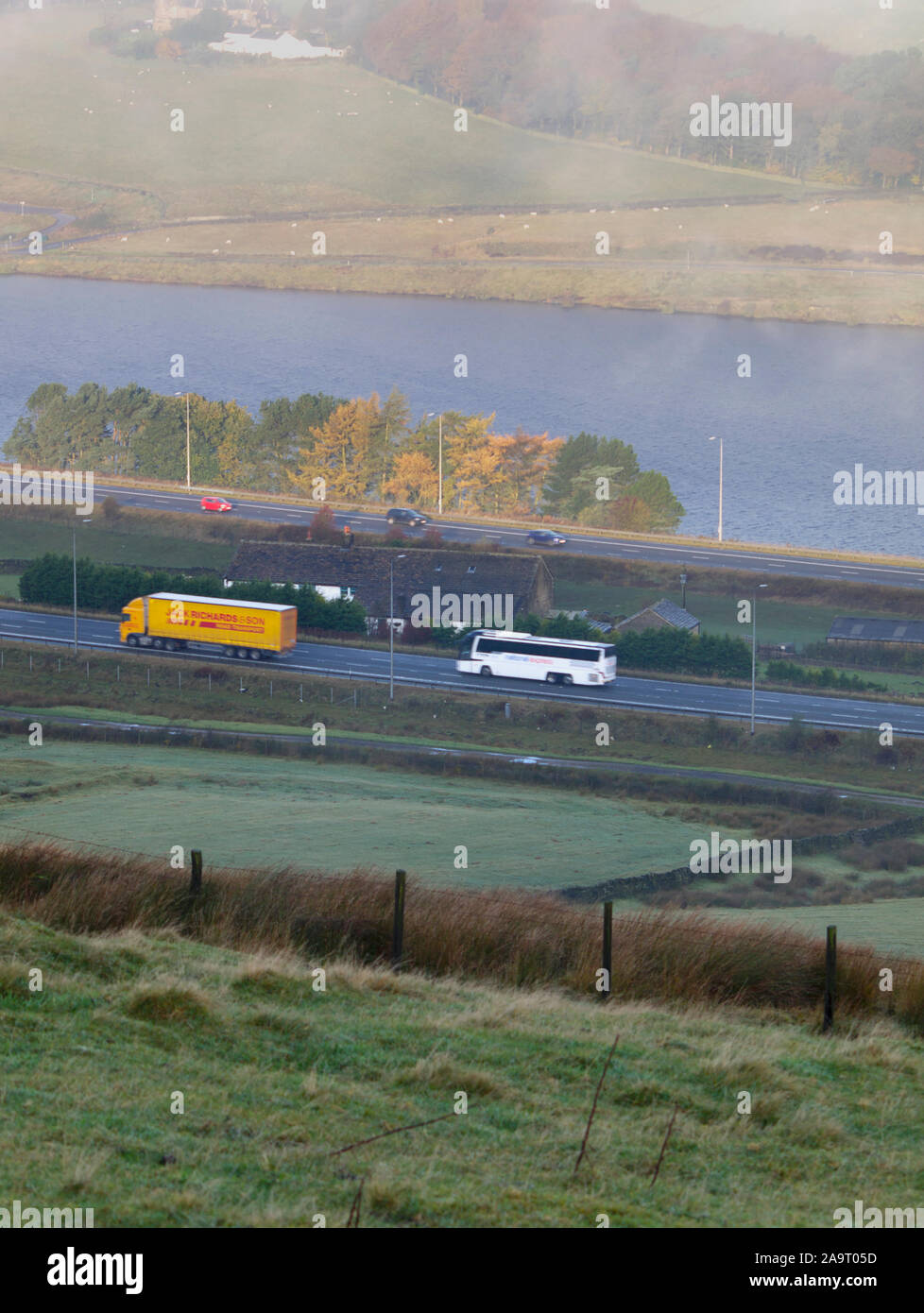 Stott Hall Farm and M62 in the mist fog from B6114 Saddleworth Road near Moselden Height Scammonden Stock Photo