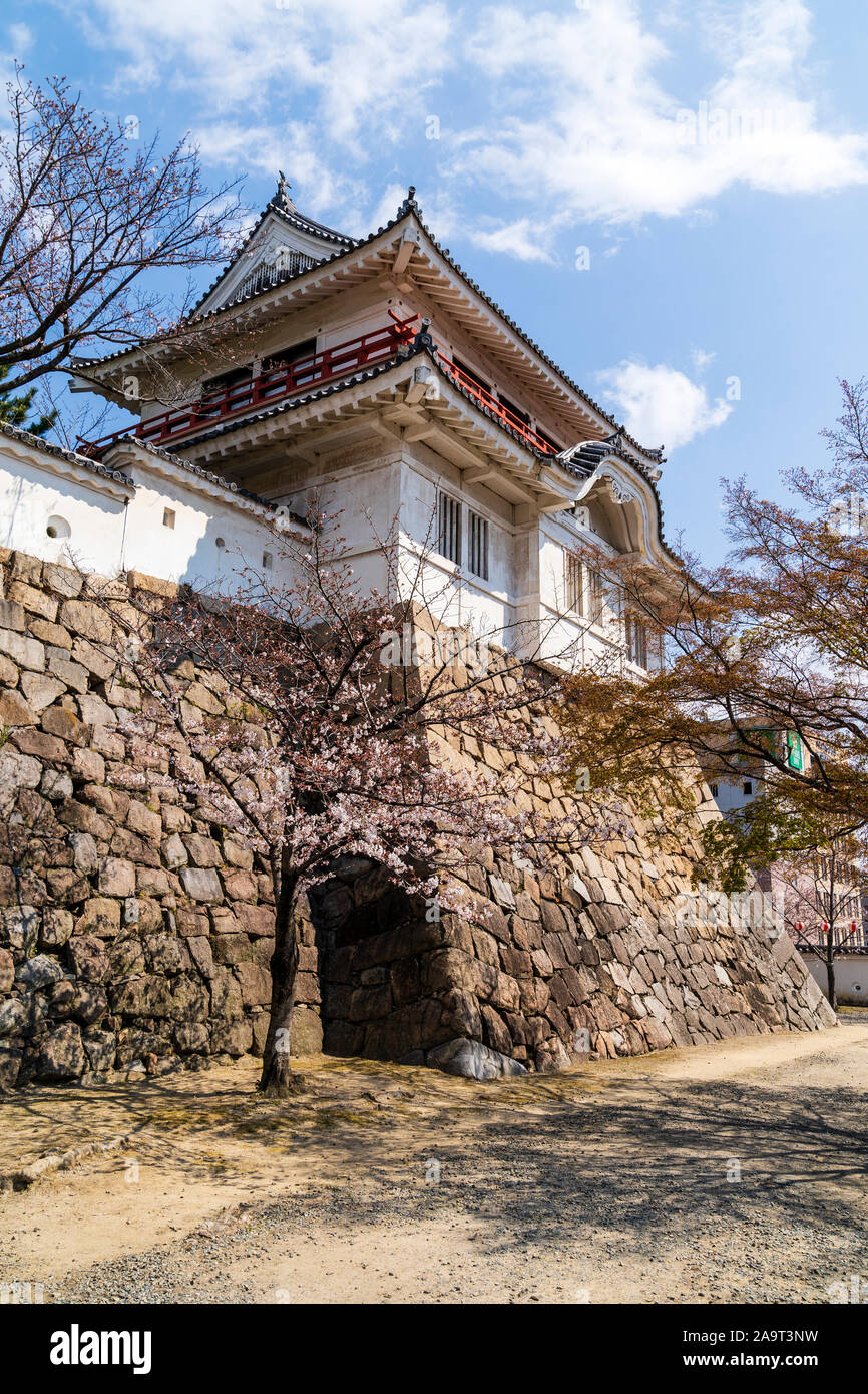 Fukuyama castle in Japan. The Tsukimiyagura, the two story moon viewing turret on the corner of the Honmaru, atop of ishigaki stone walls. Blue sky. Stock Photo