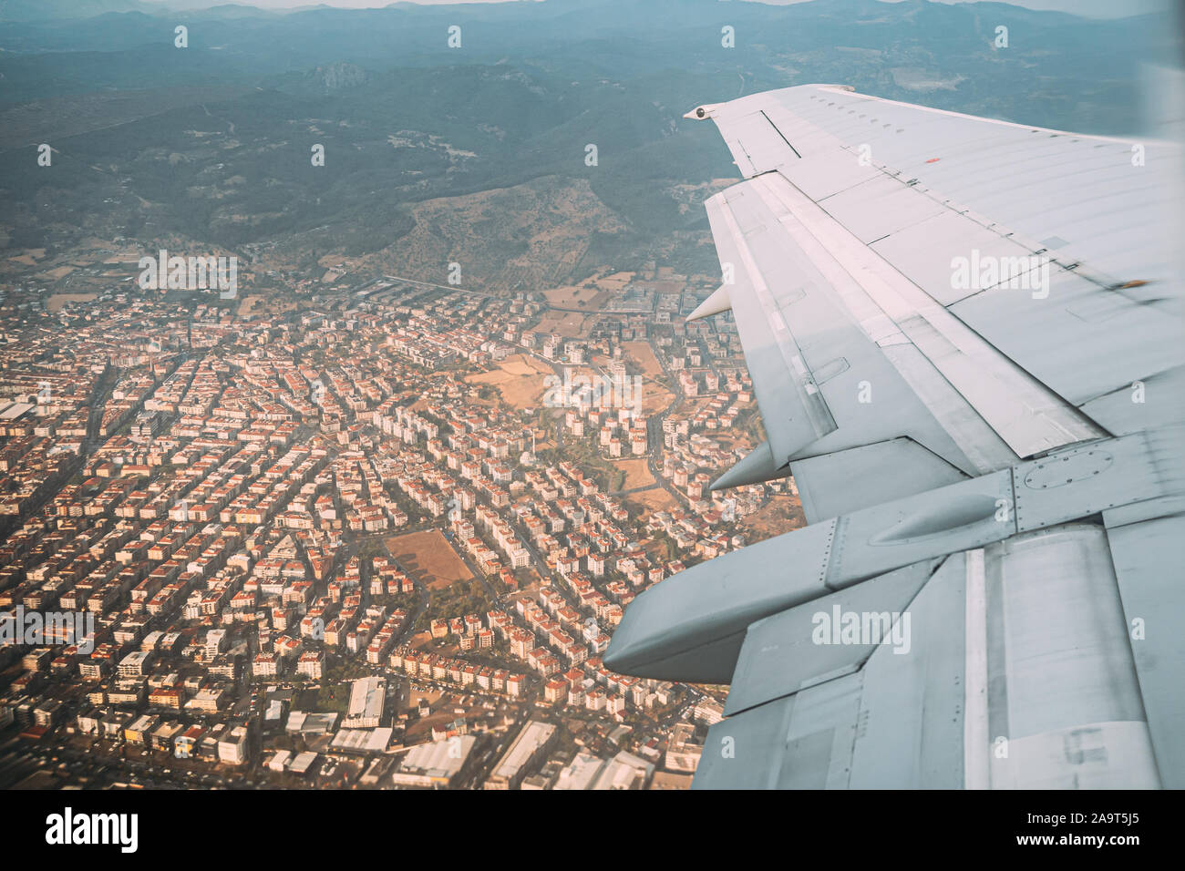 Izmir, Turkey. Beautiful Cityscape Of Turkish Town View From Airplane Window. White Residential Houses On Hillside. Real Estate Suburb In Summer Day. Stock Photo