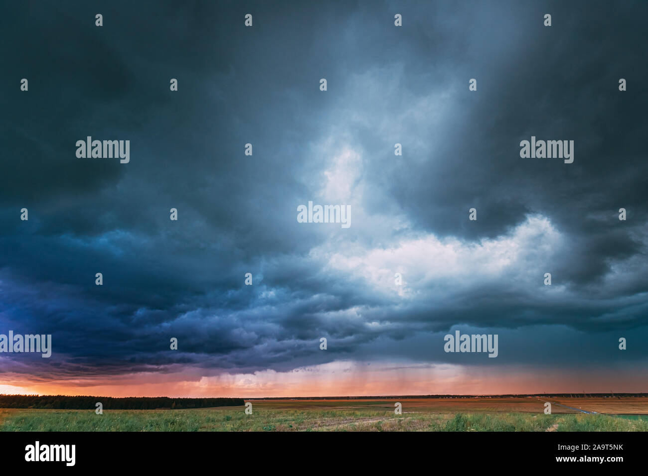 Summer Rainy Sunset Evening Above Rural Field Landscape. Scenic