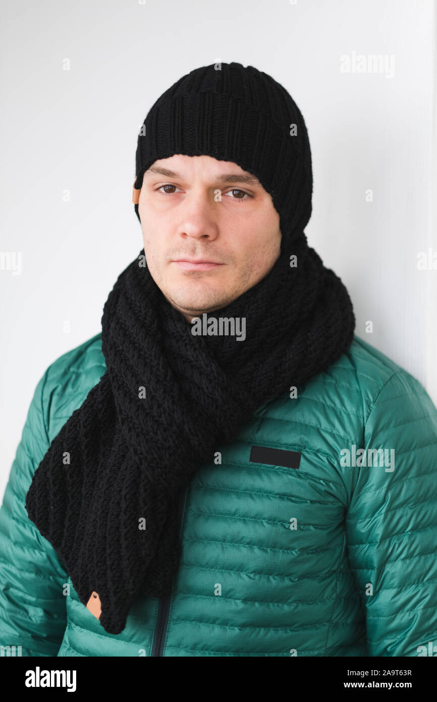 Cool man in winter fashion. Wearing scarf and knit hat Stock Photo