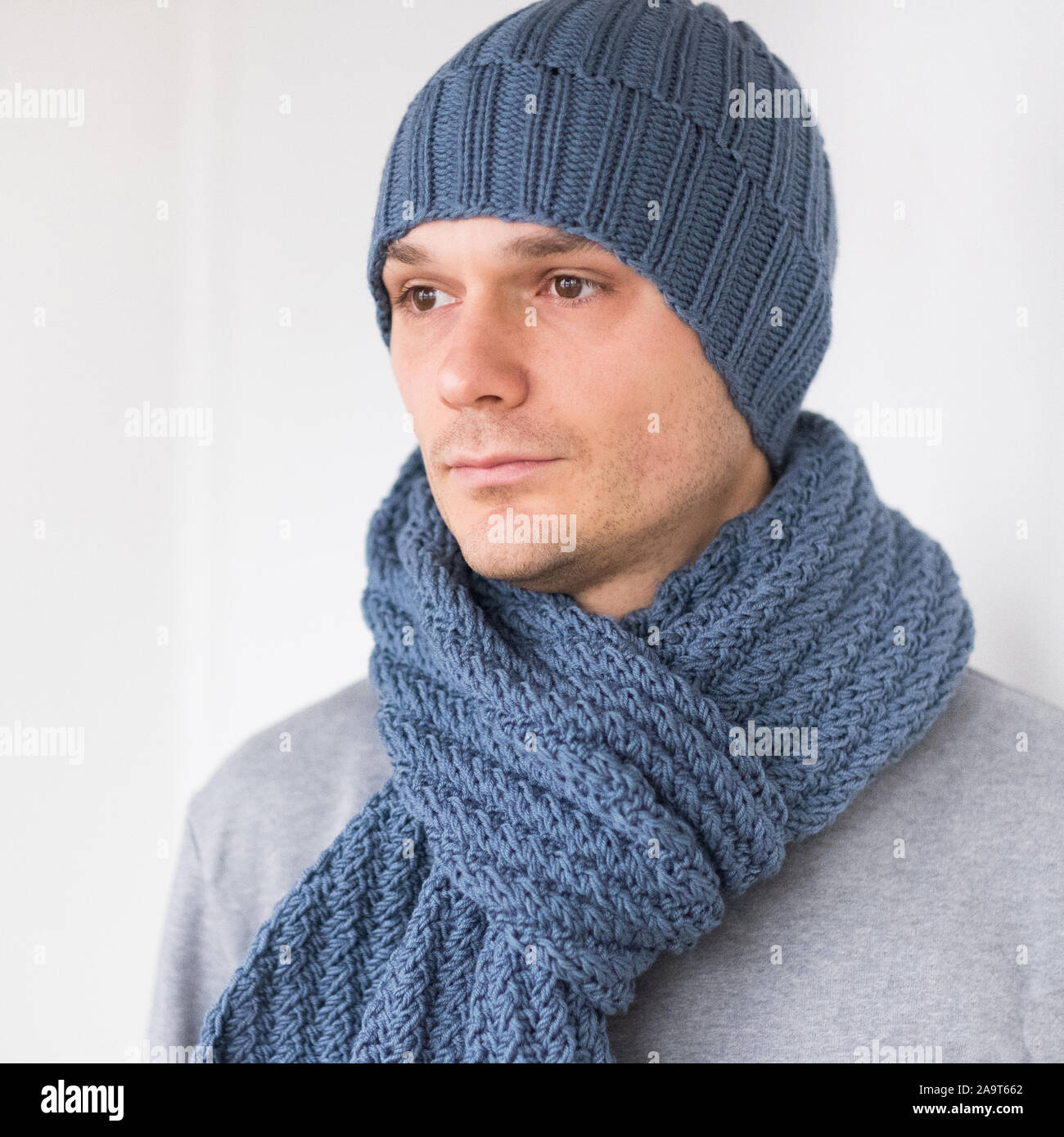 Cool man in winter fashion. Wearing scarf and knit hat Stock Photo