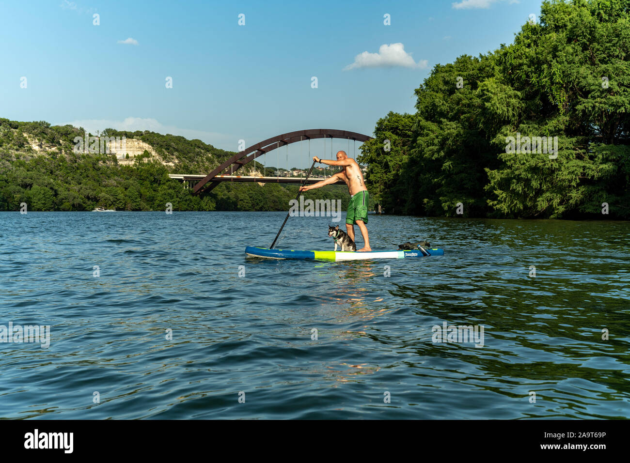 Austin, Texas, USA. 28 June, 2019. Stand Up Paddleboarding on Lake Austin. A man takes a stand