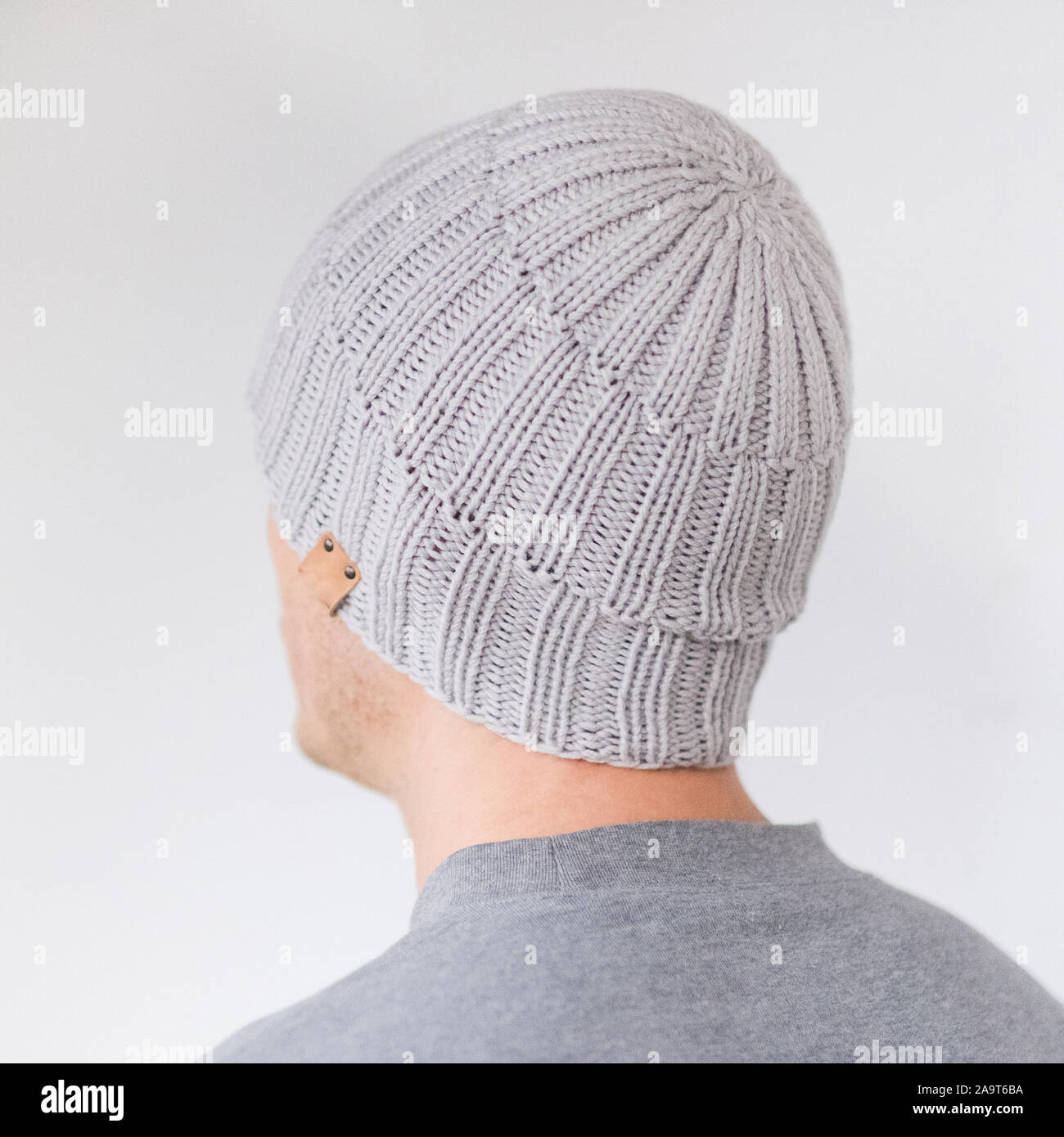 Cool man in winter fashion. Wearing scarf and knit hat Stock Photo
