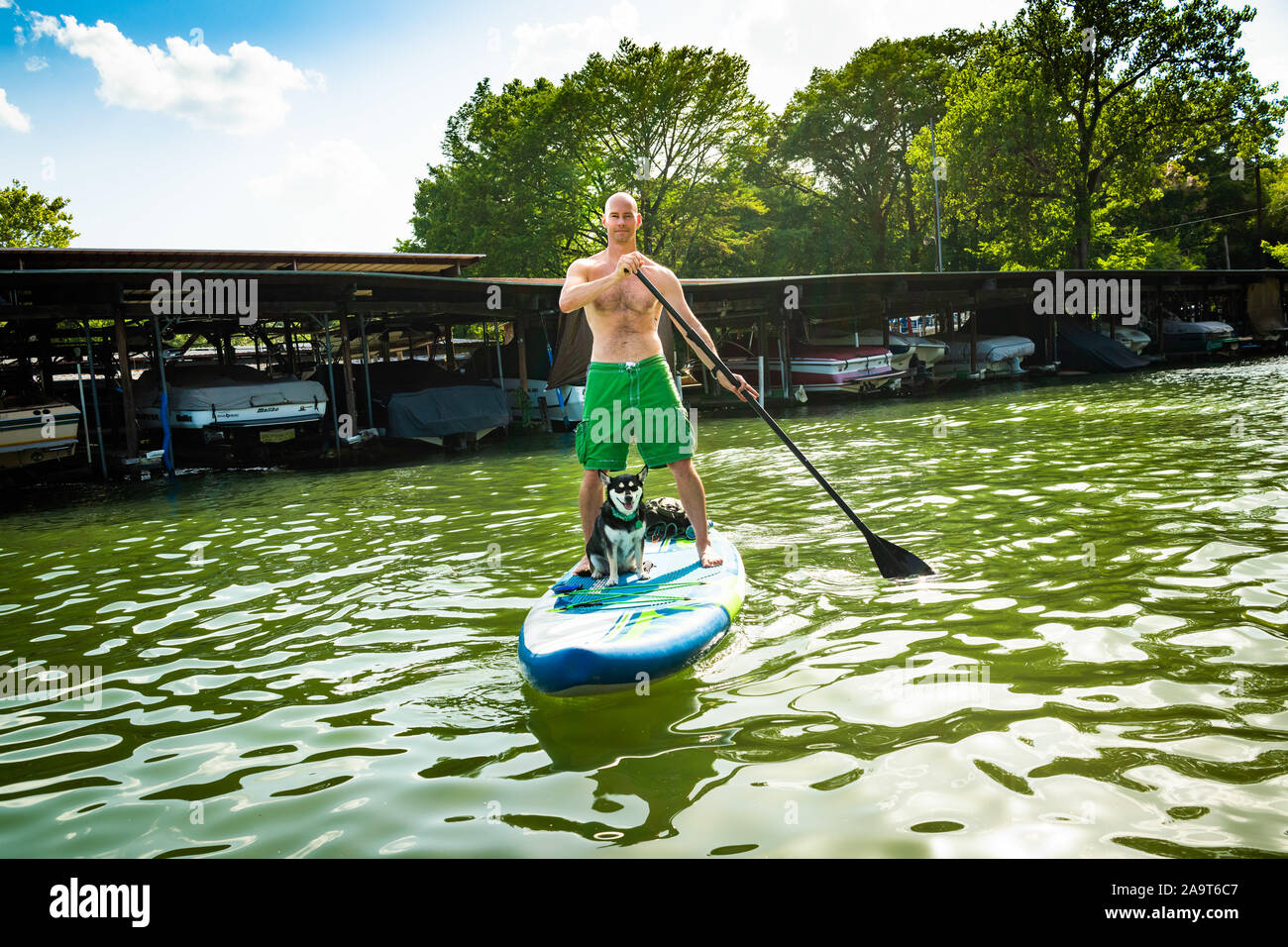 Austin, Texas, USA. 28 June, 2019. Stand Up Paddleboarding on Lake Austin. A man takes a stand