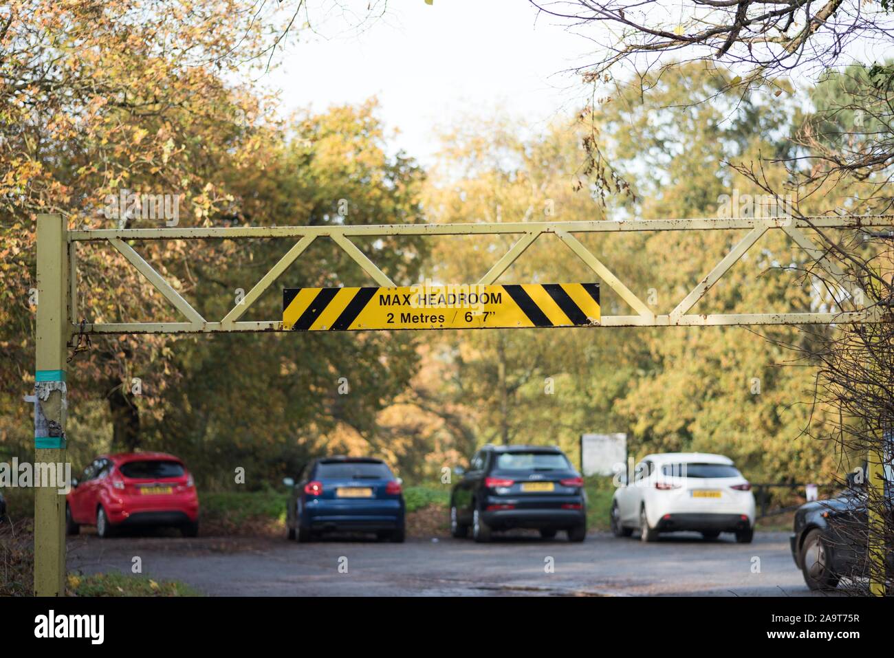 Headroom height restriction enforcement with signage and iron bars