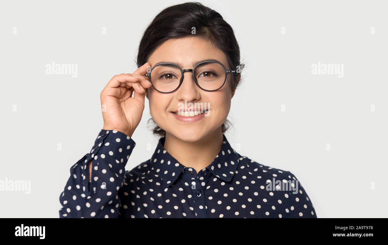 Headshot portrait smiling beautiful Indian young woman in glasses Stock
