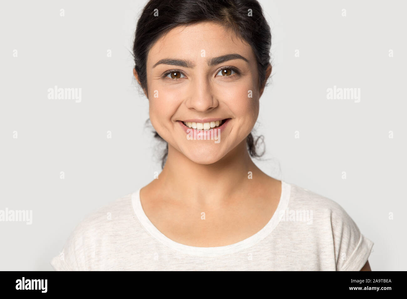 Head shot portrait beautiful Indian girl with healthy smile Stock Photo