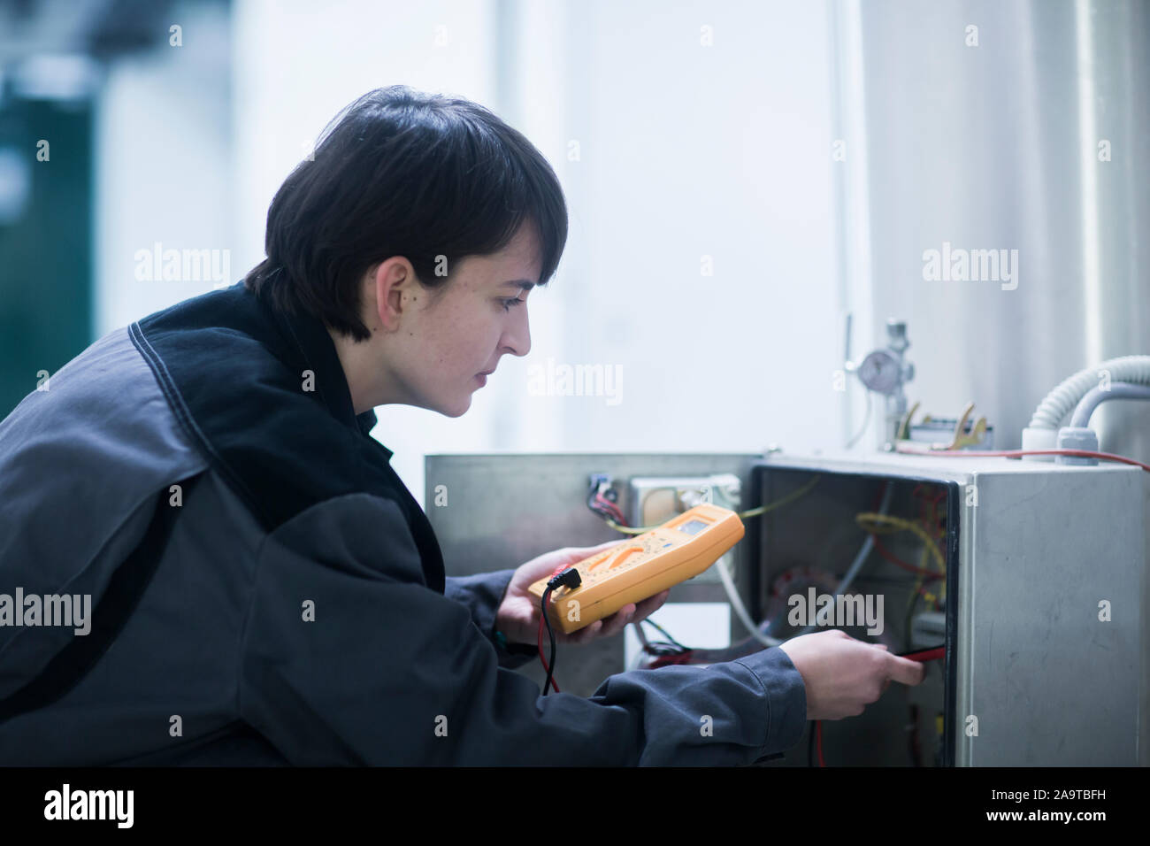 Engineer woman working indoor ckecking Stock Photo