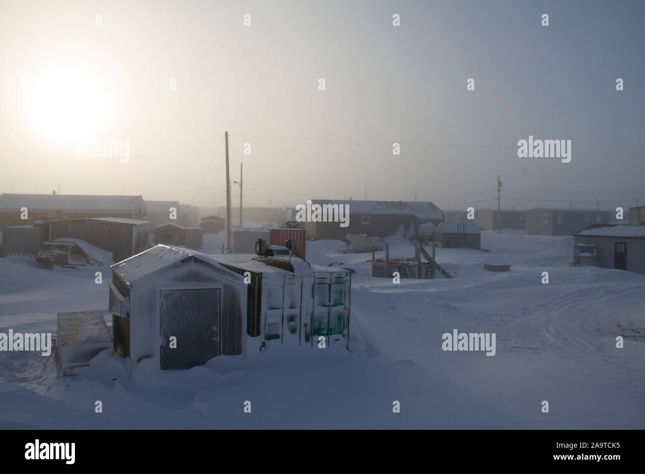 Arctic community covered in snow following a blizzard, located in