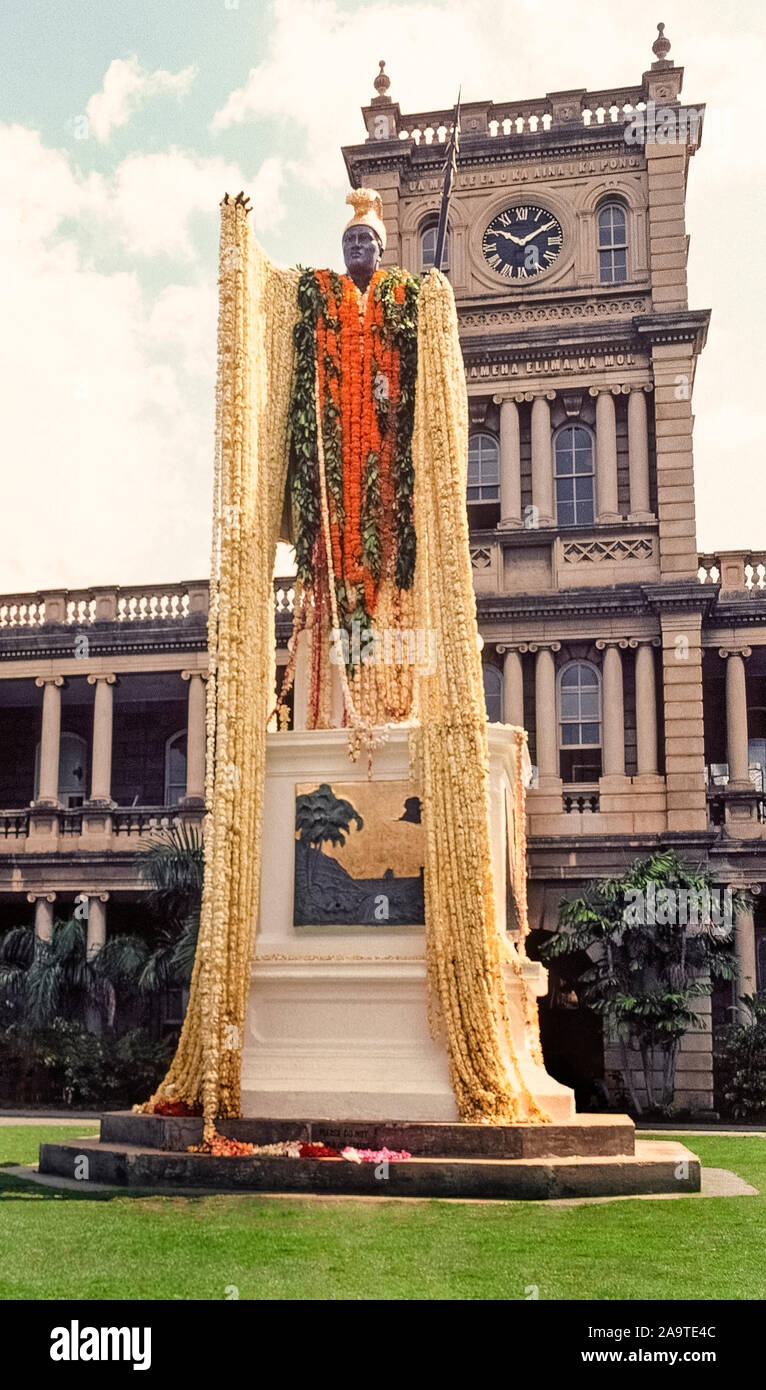 The statue of King Kamehameha I is draped with 30-foot-long plumeria flower leis for a state holiday, Kamehameha Day, celebrated annually on June 11th in the Pacific Ocean islands of Hawaii. Called Kamehameha the Great, he conquered the Hawaiian Islands and formally established the Kingdom of Hawaii in 1810, which later became the 50th state of the USA. The bronze statue with gold-leaf accents was unveiled in downtown Honolulu on the island of Oahu in 1883 and is the work of American sculptor Thomas Ridgeway Gould. The statue stands in front of the Judiciary Building. Stock Photo