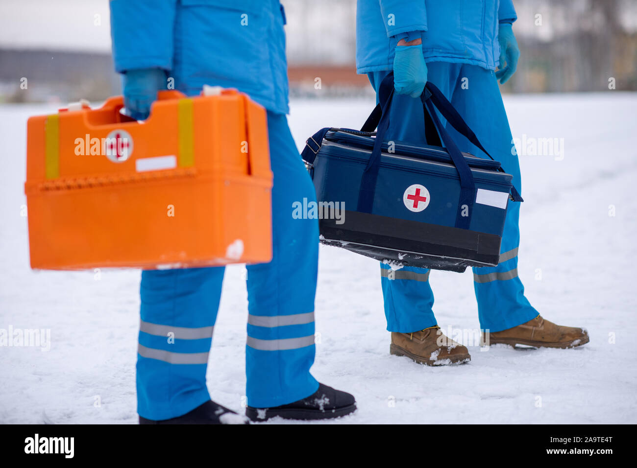 Low section of young paramedics with first aid kits ready to save sick people Stock Photo