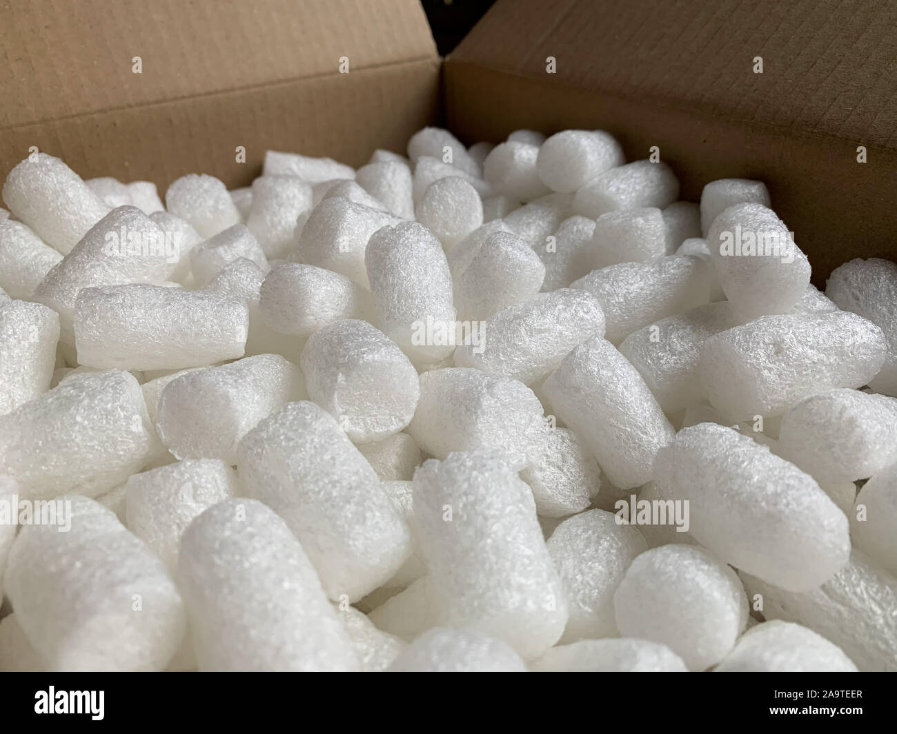 White polystyrene plastic foam elements within a parcel, to secure a safe transport. Stock Photo