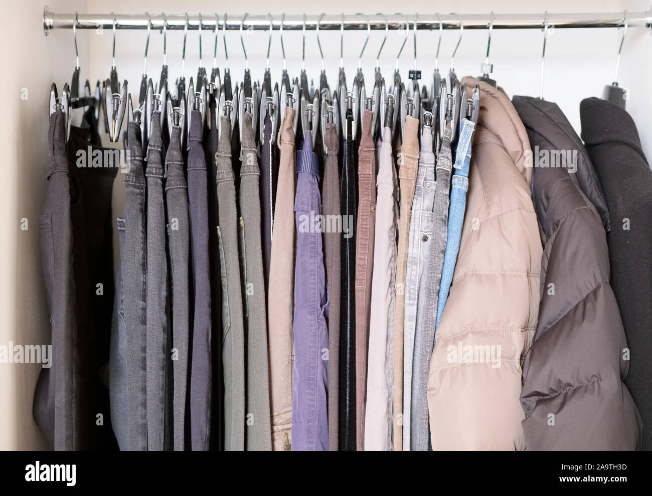 Clothes hanging up in wardrobe hi-res stock photography and images - Alamy