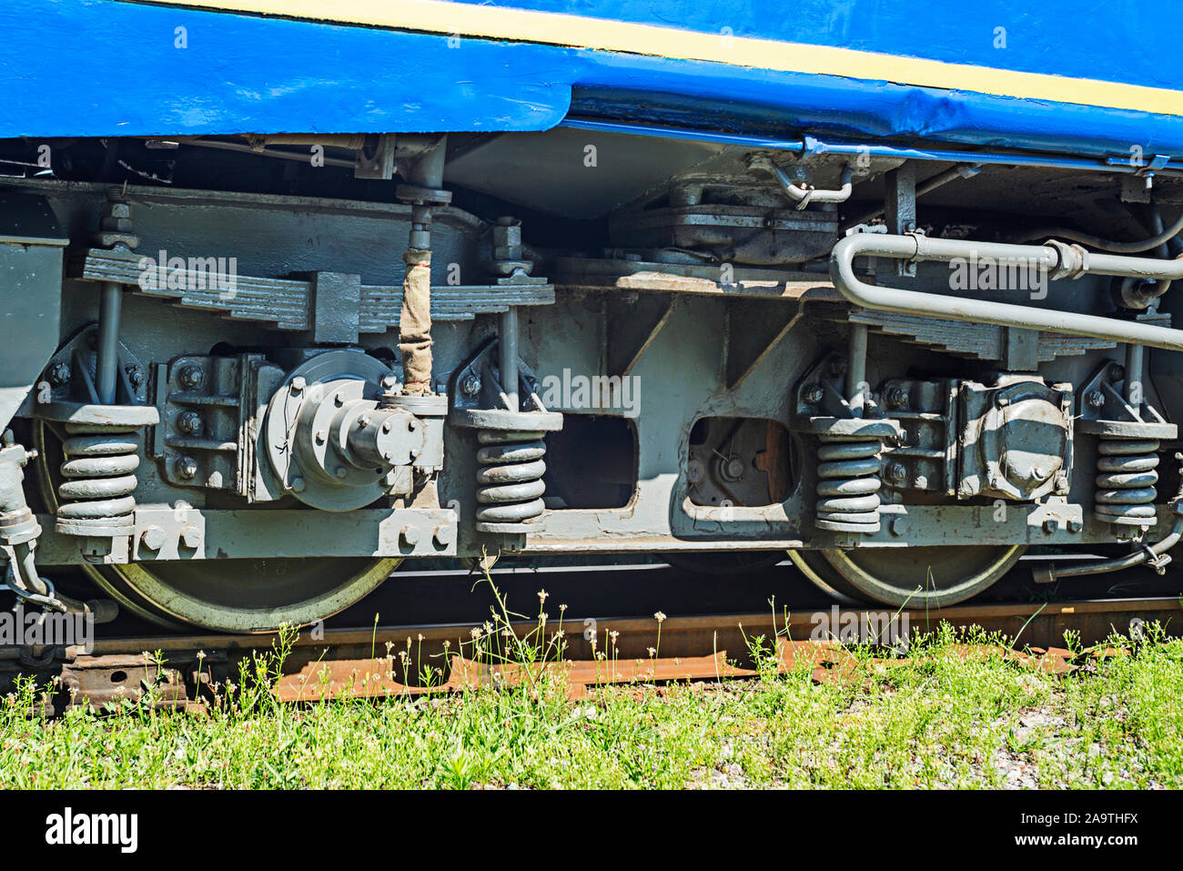 Train wheels on rail track. Wheels of a railway train on rails close up