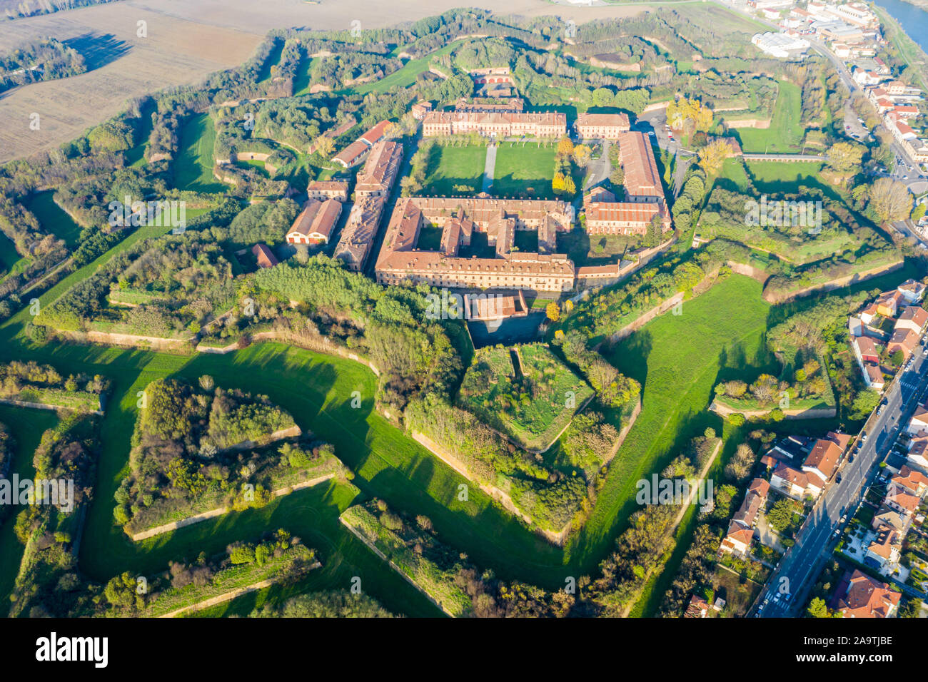 Aerial helicopter view of walls, moats, bastions, earthworks, outworks and barracks of modern six-star hexagon shaped renaissance fortress Cittadella Stock Photo