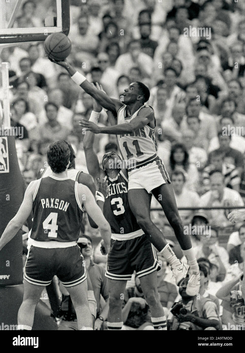Detroit Pistons #11 Isiah Thomas scores past Boston Celtics Dennis Jonhson and Jim Paxton during the NBA Semi finals game in Detroit Michigan 1988 photo by bill belknap Stock Photo