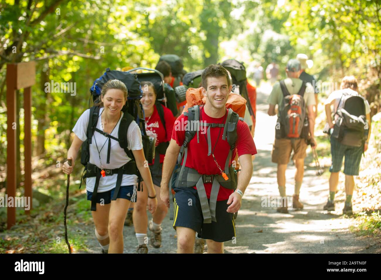 Mid shot of new Johns Hopkins University students, walking along a trail on a sunny day, during a Pre-Orientation backpacking trip on the Appalachian Trail, Maryland, August 22, 2010. From the Homewood Photography Collection. () Stock Photo