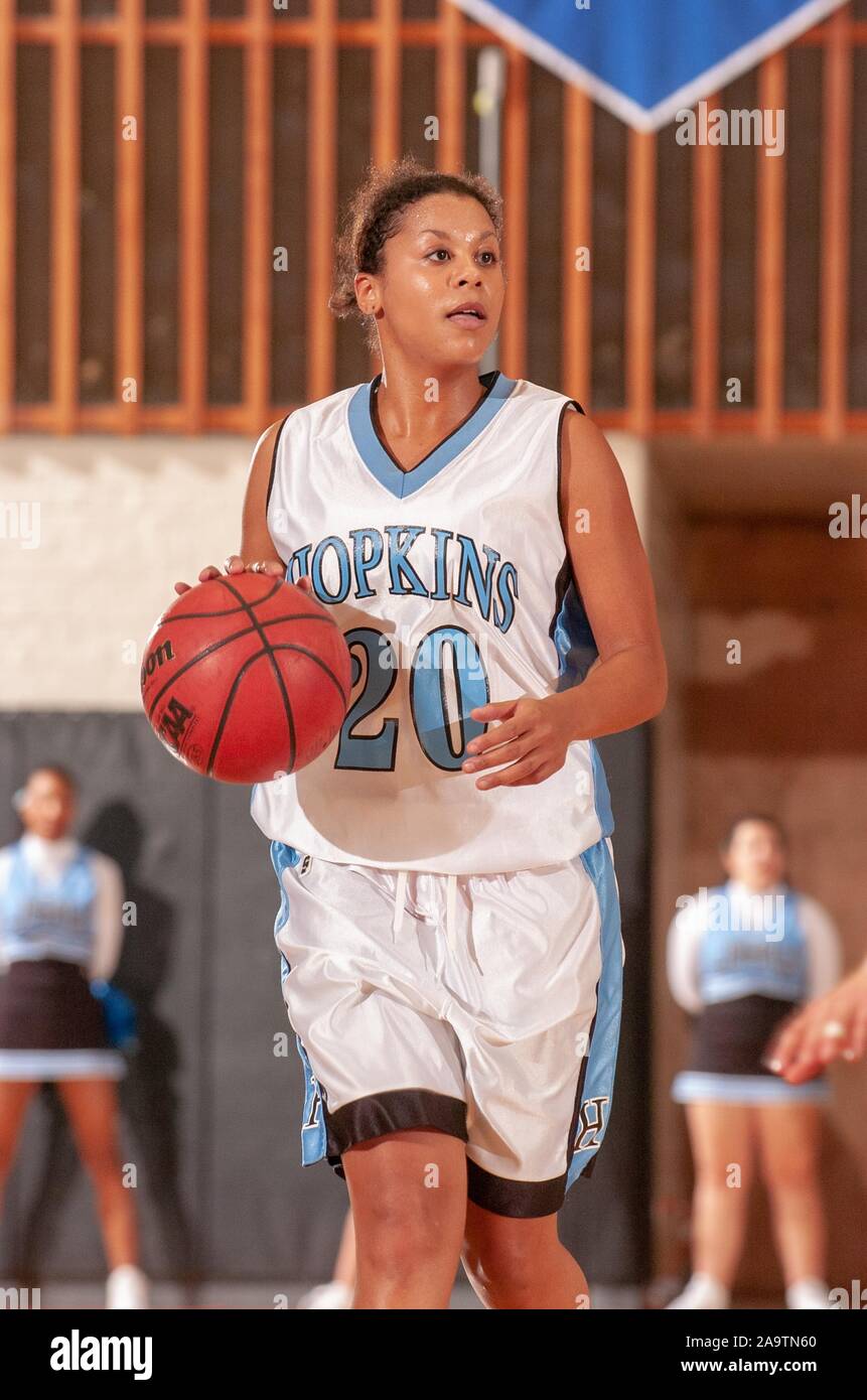 Three-quarter length shot of a player from the Johns Hopkins University Women's Basketball team, moving across the court with the ball, during a match with Lebanon Valley College, December 2, 2004. From the Homewood Photography Collection. () Stock Photo