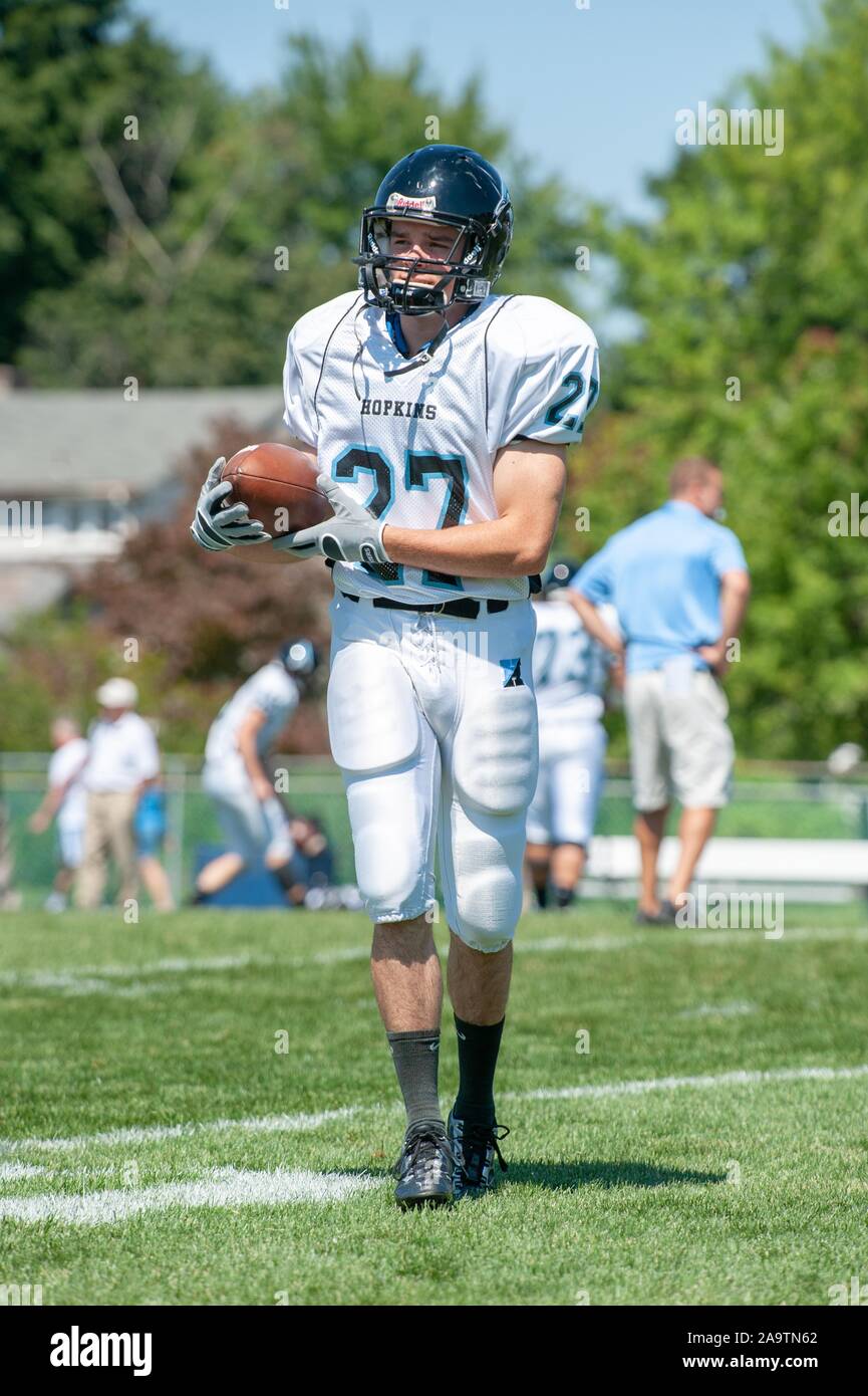 Full-length shot of a Johns Hopkins University Men's Football player, on a sunny day, walking while holding the ball during match with Delaware Valley University, September 5, 2009. From the Homewood Photography Collection. () Stock Photo