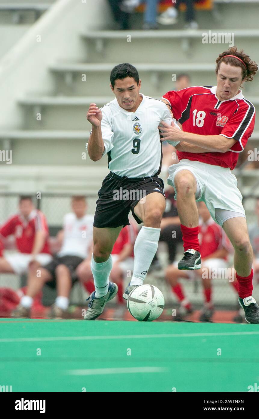 Full-length shot of a player from the Johns Hopkins University Men's Soccer team vying for the ball against an opponent, during a match with Dickinson College, October 2, 2004. From the Homewood Photography Collection. () Stock Photo