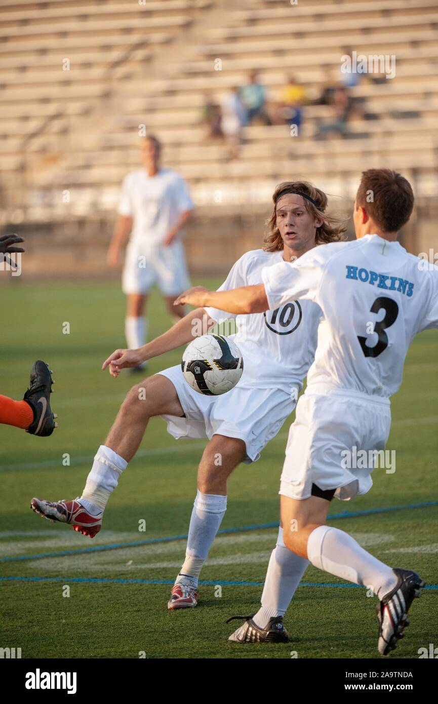 Two Johns Hopkins University Men's Soccer players attempt to capture the ball during a match with Buffalo State, September 4, 2009. From the Homewood Photography Collection. () Stock Photo