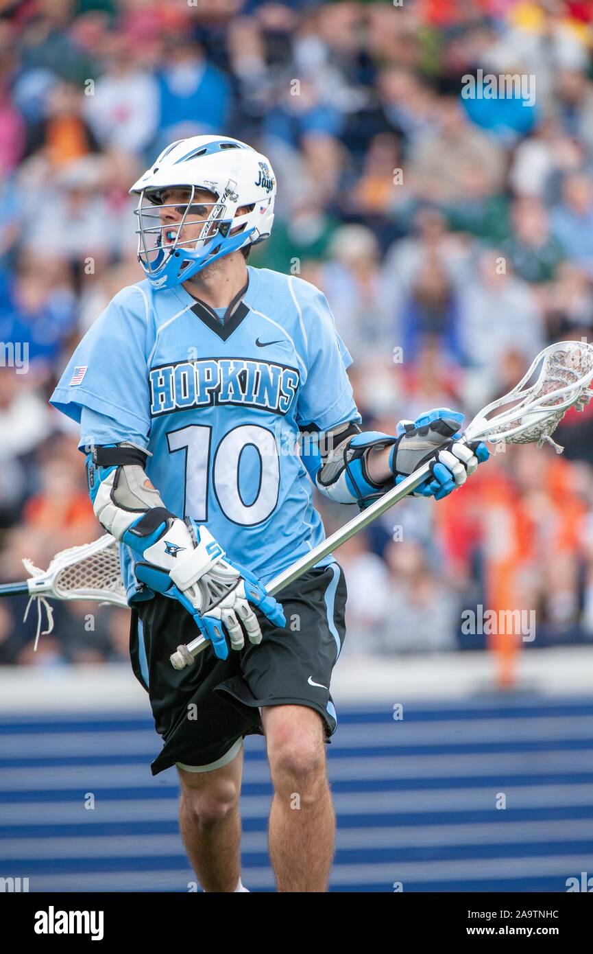 Full-length shot of a helmeted Johns Hopkins University Men's Lacrosse player, moving across the field with the ball in his net during a National Collegiate Athletic Association quarterfinals match with the University of Virginia, May 17, 2009. From the Homewood Photography Collection. () Stock Photo